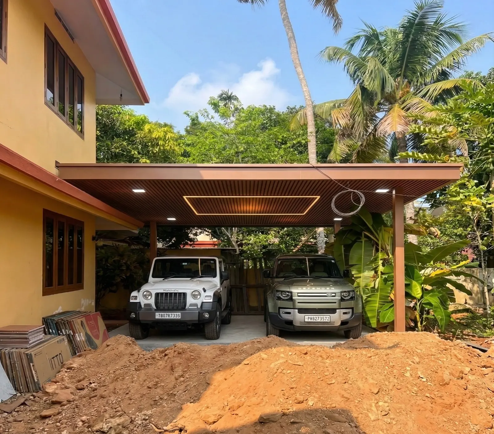 Aluminium car porch with an ACP roof, lit ceiling and louvred side screens