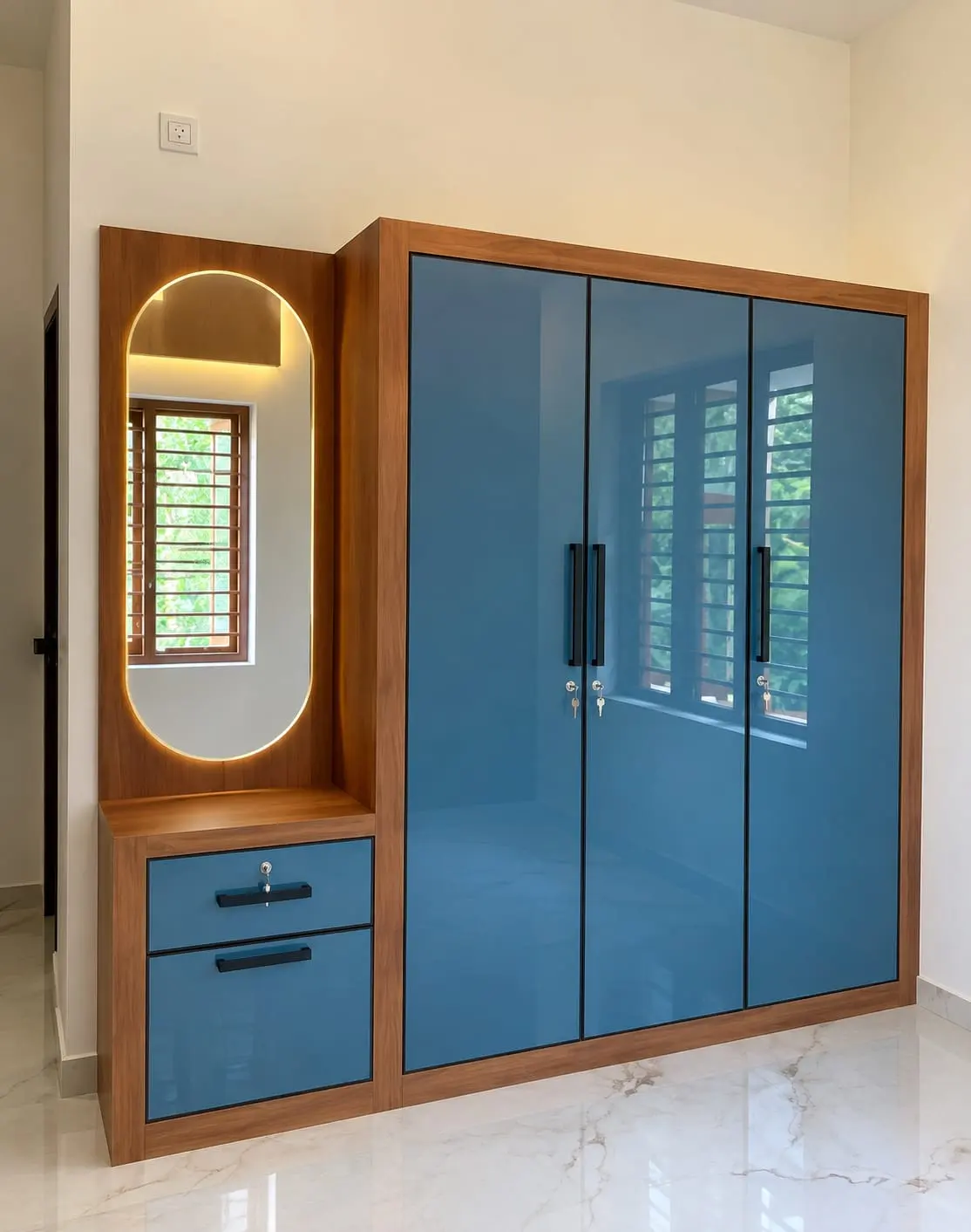 Blue glass-shutter wardrobe with a dressing unit and a lit mirror